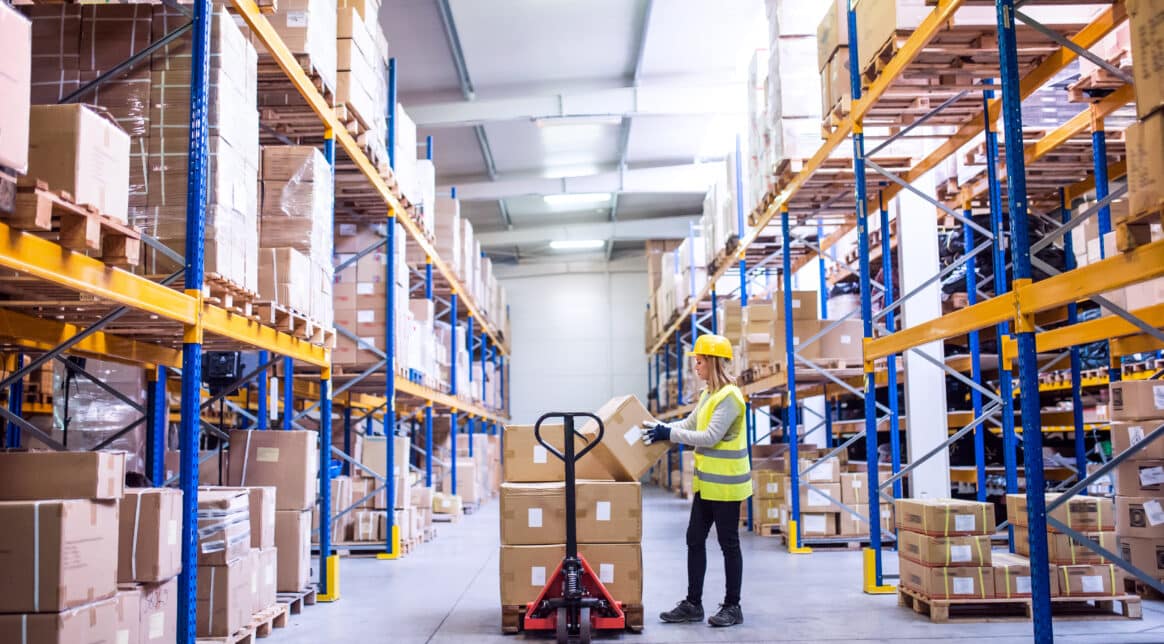 Female warehouse worker loading boxes