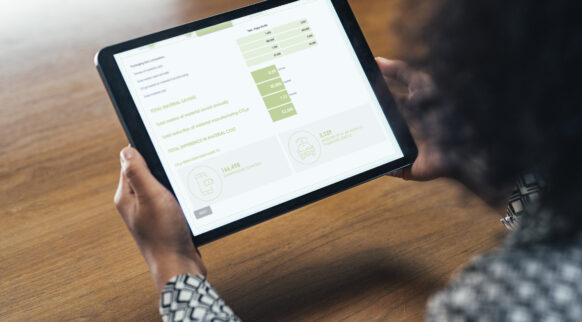 Close Up: Anonymous Businesswoman Analyzing Statistical Business Reports on her Tablet PC at the Office