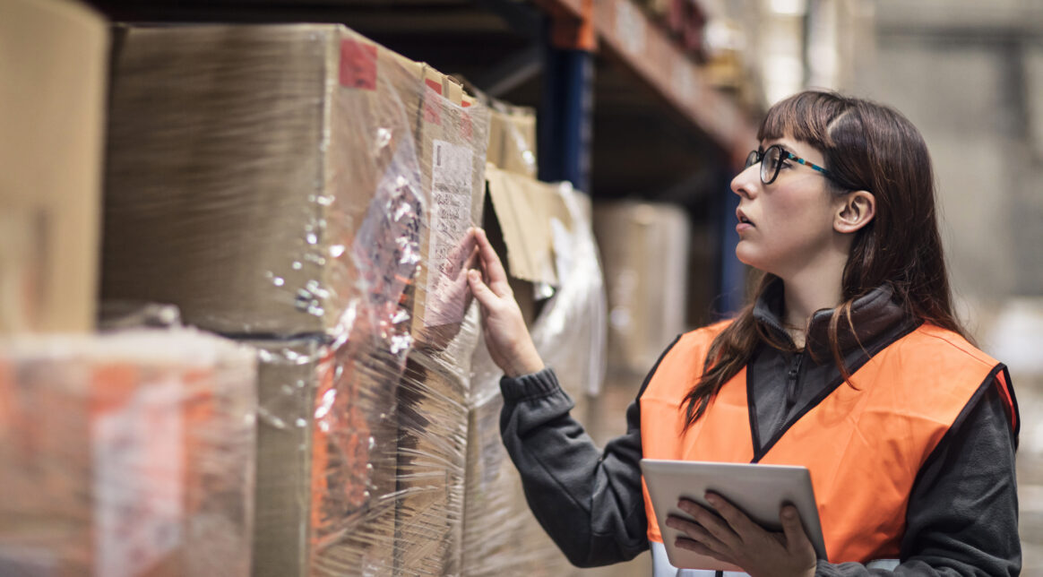 Warehouse worker checking boxes in stock in a warehouse